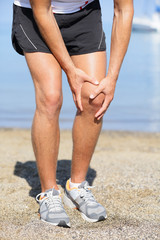 Running injury - Man out jogging with knee pain