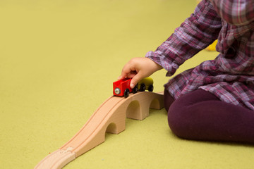 Little kid playing with train construction.