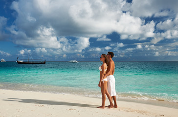 Fototapeta na wymiar Couple on a beach at Maldives
