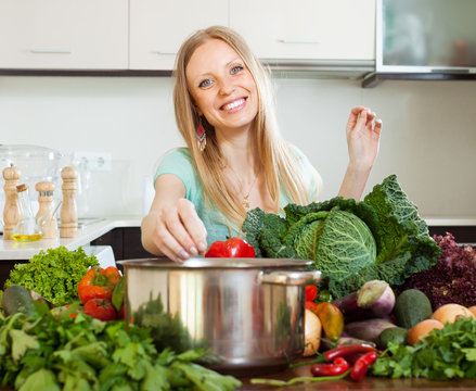 Portrait of happy blonde woman with  vegetables