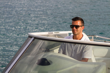 Handsome Young man on his yacht