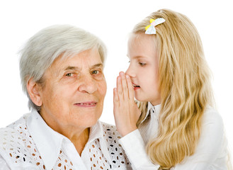 girl telling an astonished old woman some secrets. isolated 