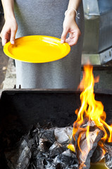 Chinese woman burning golden paper for ancestor.