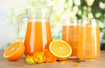 Glasses and pitcher of orange juice