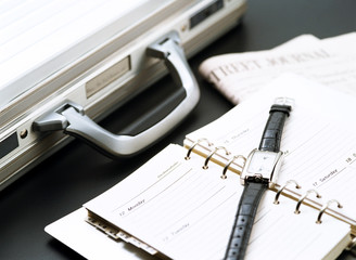 briefcase and wrist watch