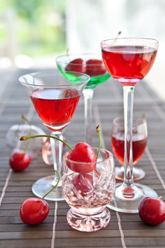 Various little glasses with cherry liquor