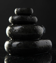 Fototapeta na wymiar Stack of spa hot stones isolated on black