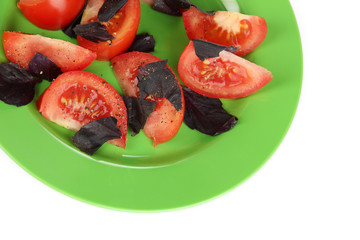 Salad of fresh tomatoes with basil leaves isolated on white