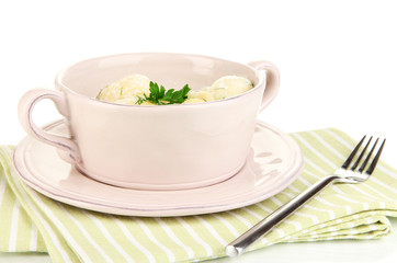 Tender young potatoes with sour cream and herbs in pan isolated