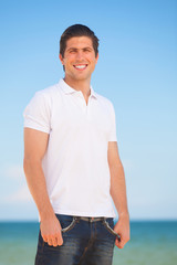 Handsome young man at beach background