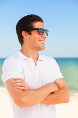 Handsome young man at beach background