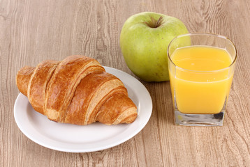 Classical breakfast. Orange juice and croissant