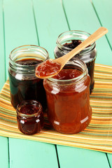 Tasty jam in banks on table
