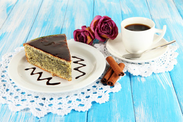 Delicious poppy seed cake with cup of coffee on table close-up