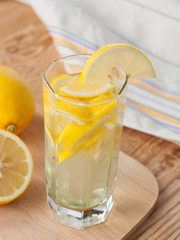 Lemon drink in a glass and lemons