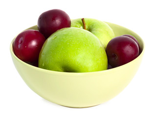 Washed apples and plums on the plate