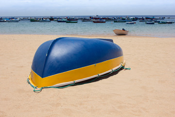 colorful fisher boats in blue turquoise sea on the beach