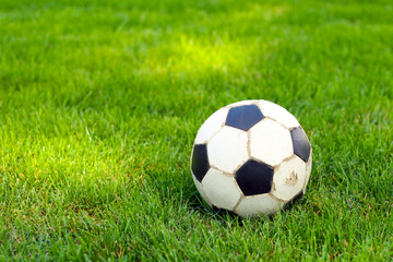 Fototapeta premium old football, soccer ball on the grass