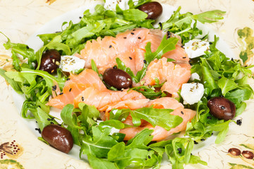 Smoked salmon and arugula salad, viewed from above