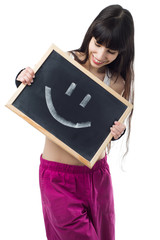 Sporty girl holding a chalkboard with a smiling face