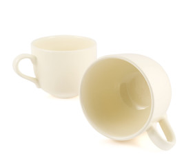 Two ceramic cream colored cups composition