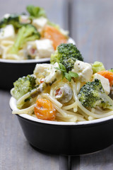 Vegetarian pasta with broccoli, ricotta, basil, carrot and olive
