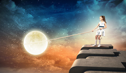 Little girl pulling moon