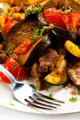 Grilled meat with French fries and vegetables