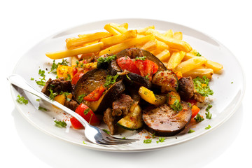 Grilled meat with French fries and vegetables