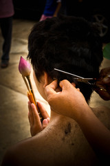 Shaving heads for ordination. Buddhist religious traditions