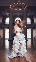 Redhead bride standing in a beautiful room