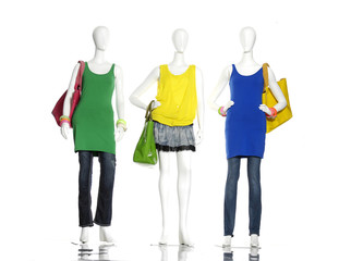 Obraz premium full-length female clothes with bag on three mannequin