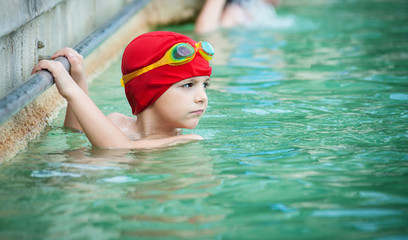 Fototapeta na wymiar Kid in thermal swimming pool.