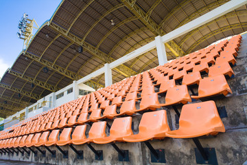Naklejka premium Stadium Orange Chair with roof and blue sky