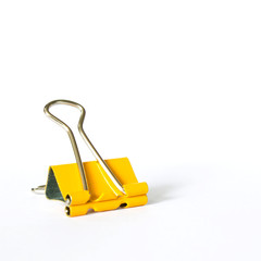 Yellow metal paperclips on white background