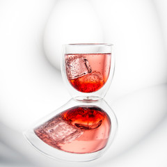 Red cool cocktail with ice cubes
