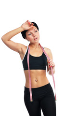 Young fitness woman measuring her waist