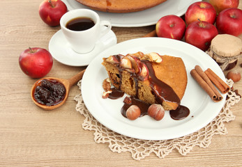 slice of tasty homemade pie with chocolate and apples and cup