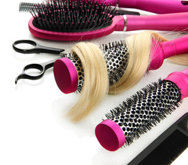 Comb brushes, hair and cutting shears, isolated on white