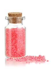 Little bottle full with colorful beads isolated on white