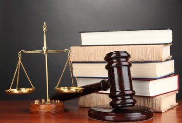 Wooden gavel, golden scales of justice  and books