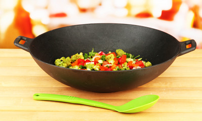 Vegetable ragout in wok, on bright background