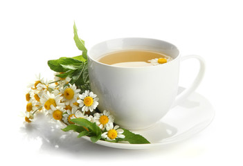 Cup of herbal tea with wild camomiles and mint, isolated