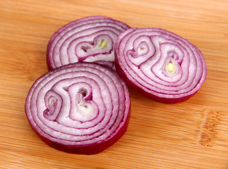 Purple onion on cutting board isolated on white
