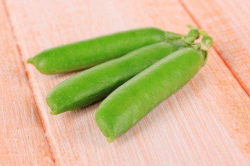 Sweet green peas on wooden background