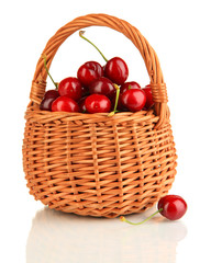 Ripe red cherry berries in basket isolated on white