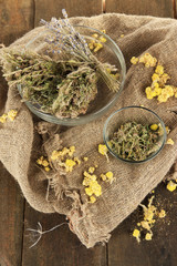 Medicinal Herbs in glass bowls on bagging close-up