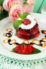 Tasty jelly dessert with fresh berries, on pink roses