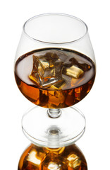 Brandy glass with ice on grey background