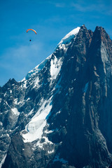 Red paraglide over Alps peaks